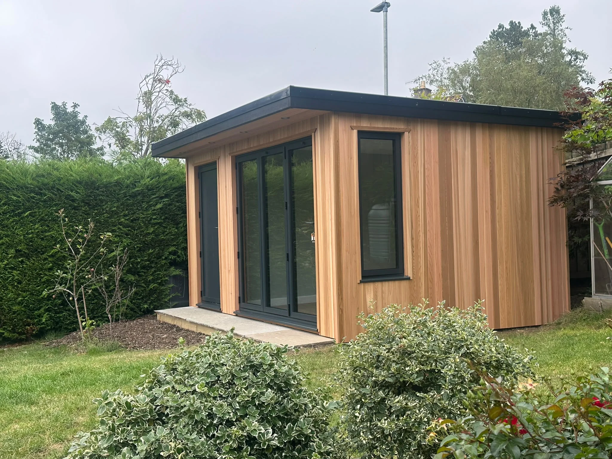Bespoke garden room with timber cladding and full-height windows